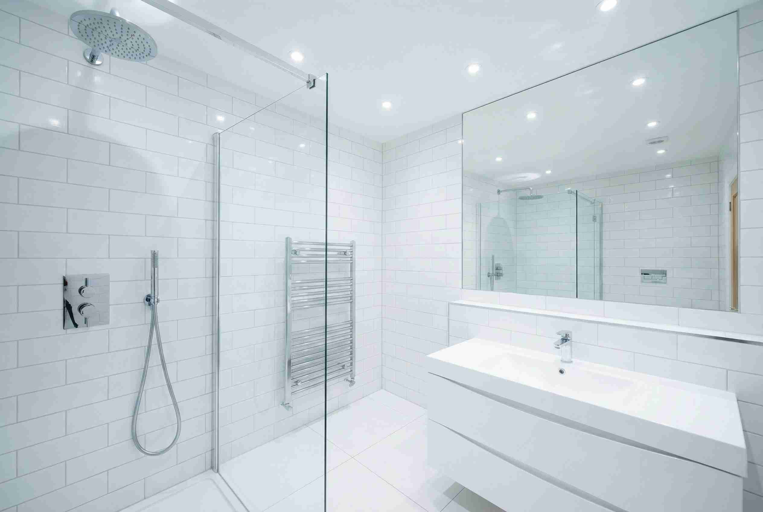 A bright, modern bathroom featuring clean LED downlights